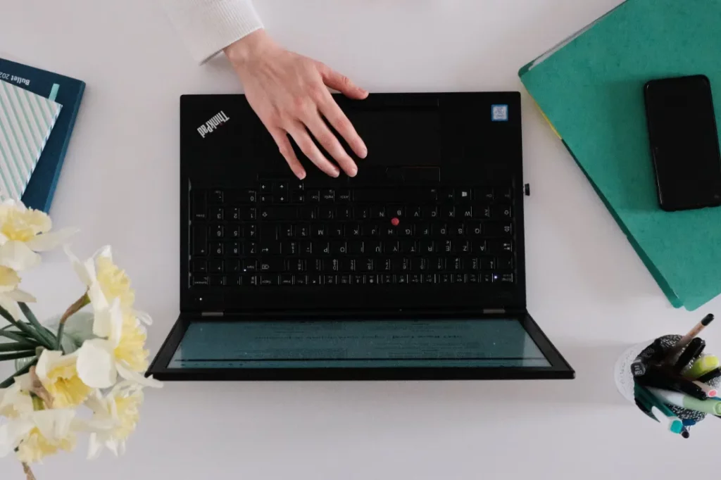 Photo prise de haut où on voit Maëva Campos, consultante SEO écrire au clavier de son ordinateur portable.